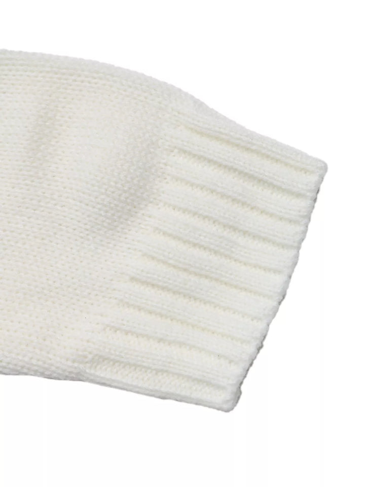 Close-up of the white sweater sleeve with ribbed cuff