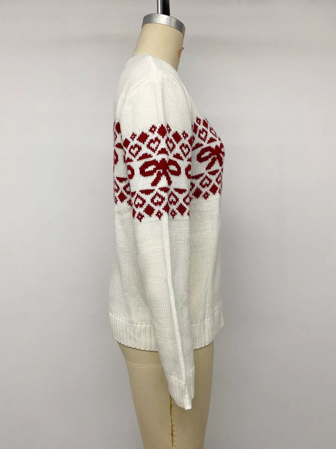 Side view of the white heart jacquard sweater on a mannequin