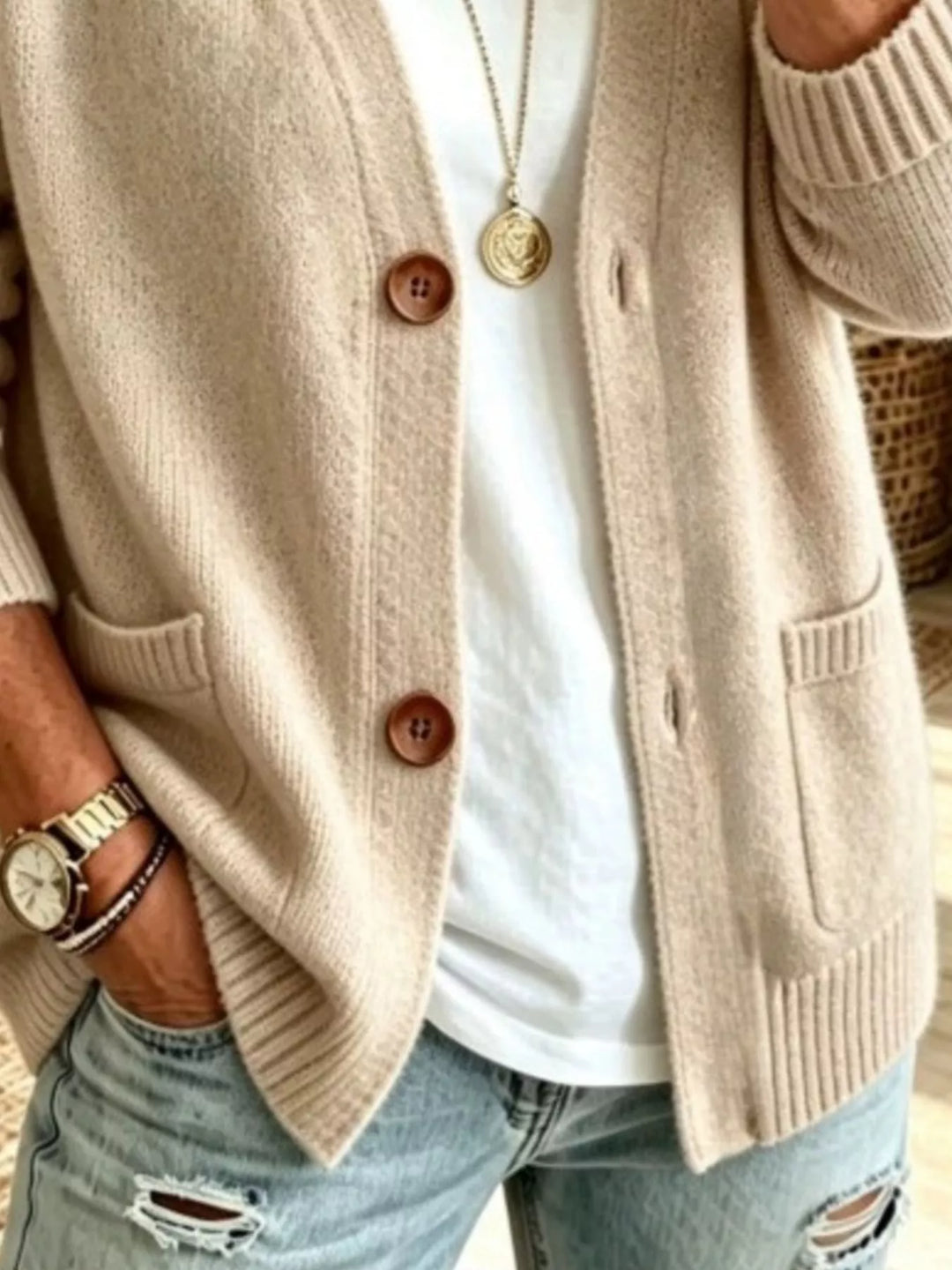 Detail of the beige cardigan patch pockets and button front