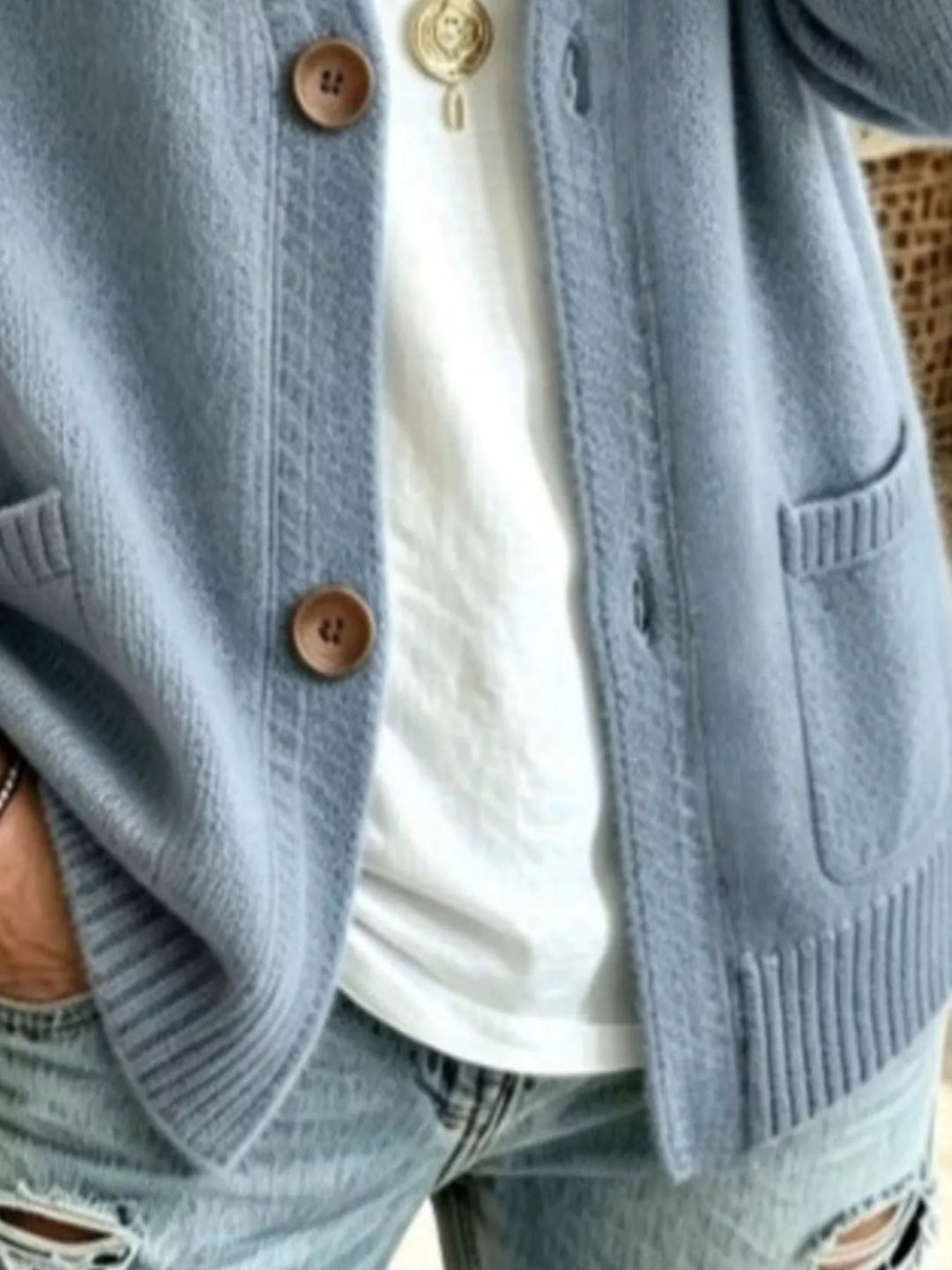 Detail of the light blue cardigan patch pockets and button front