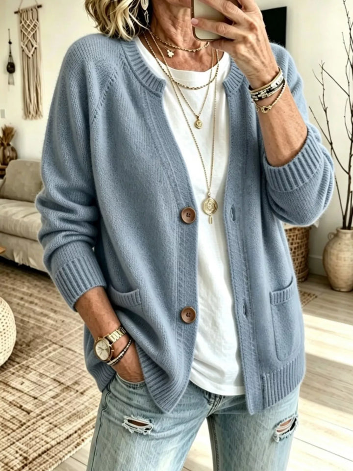 Light blue crew neck raglan cardigan with patch pockets, front view
