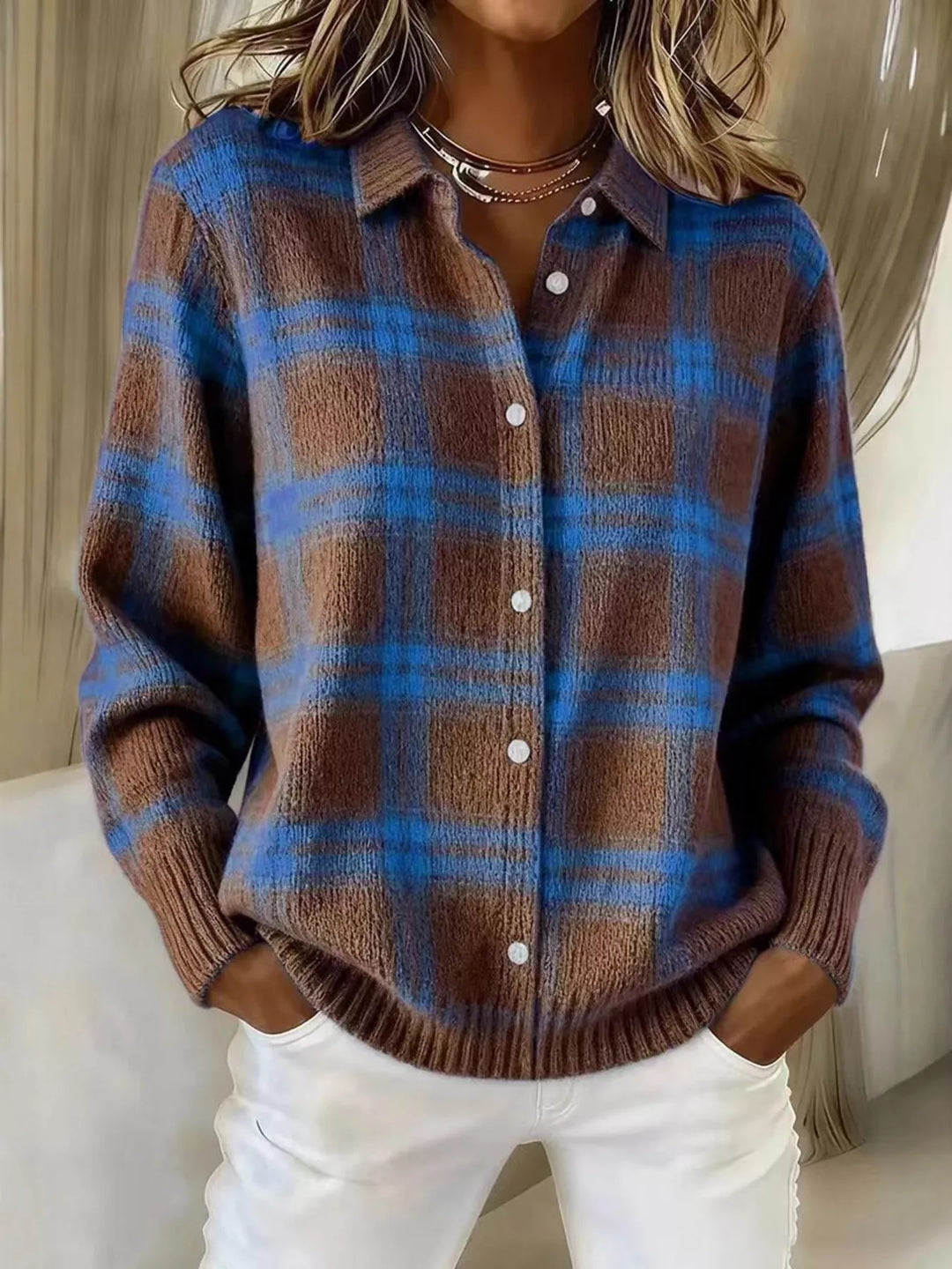 Brown and blue plaid button up cardigan worn with white pants