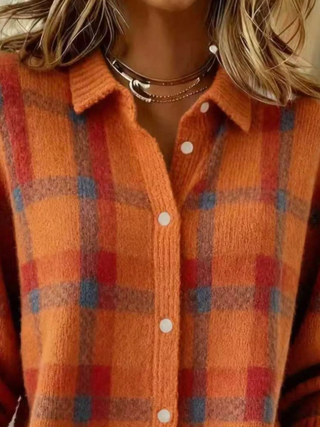 Close-up of the orange plaid cardigan collar and red check