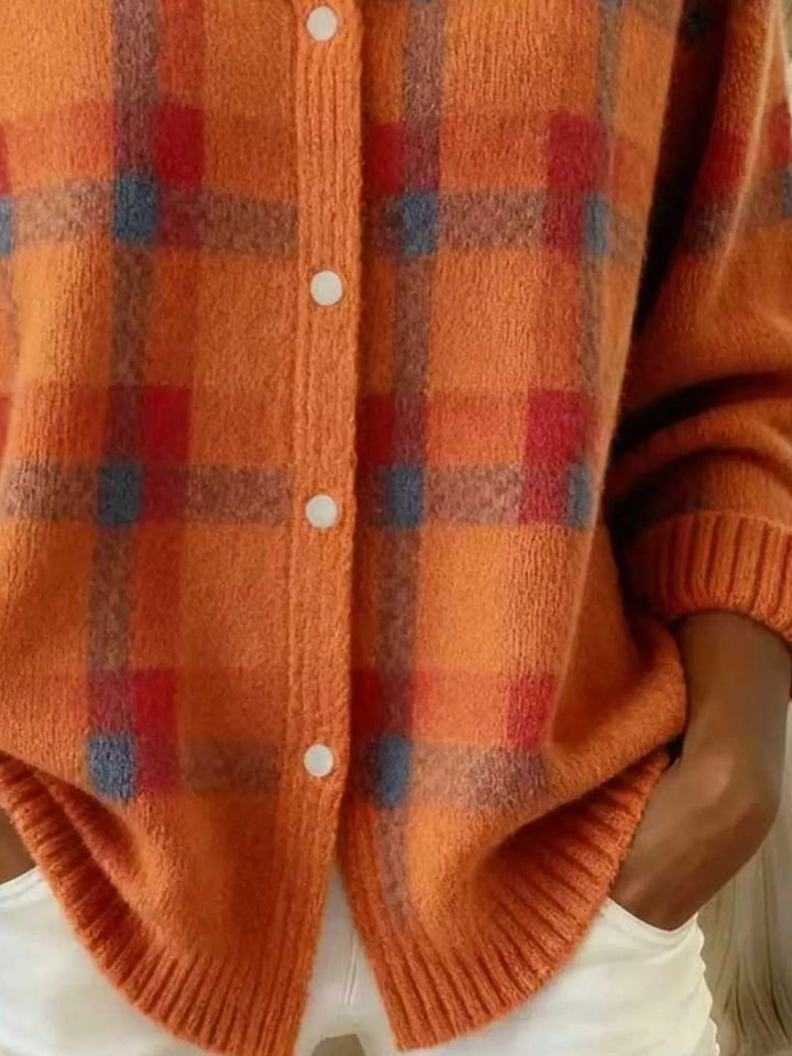 Detail of the orange plaid cardigan buttons and split hem