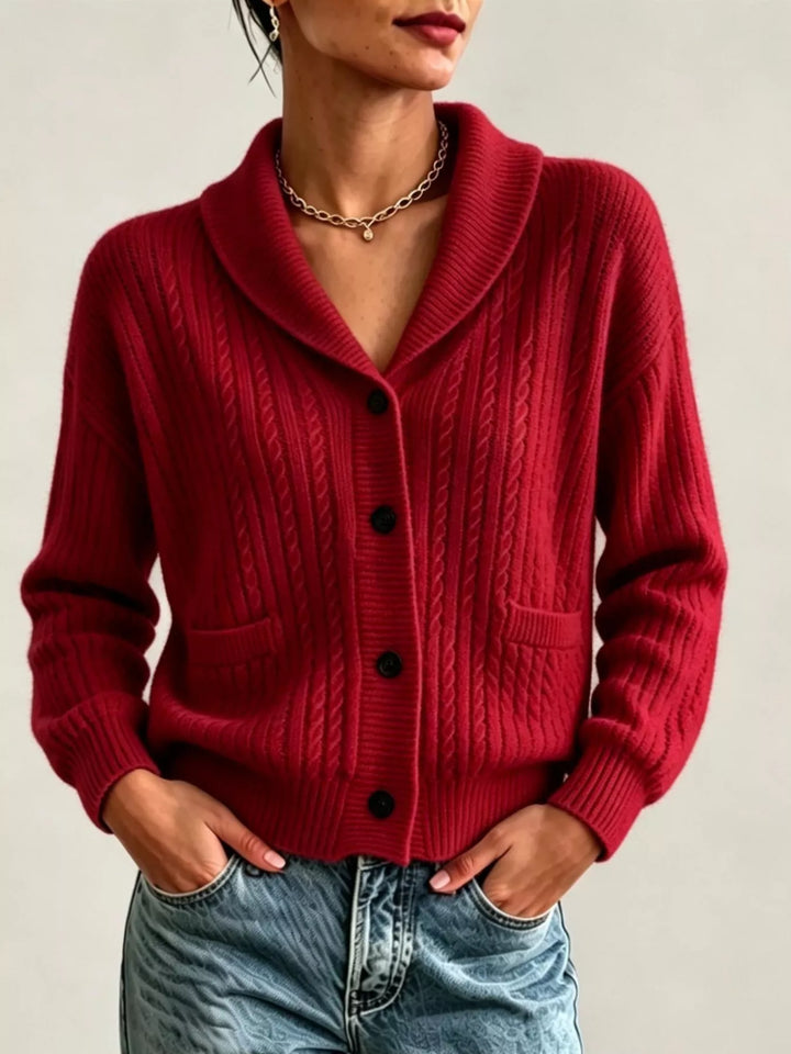 Burgundy shawl collar cable knit cardigan with pockets, hands in jeans pockets