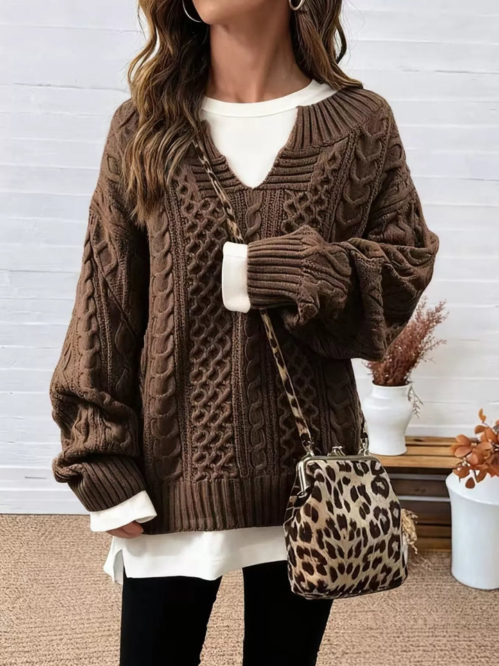 Women's cable knit sweater in brown, oversized v neck with side slits, with a leopard bag