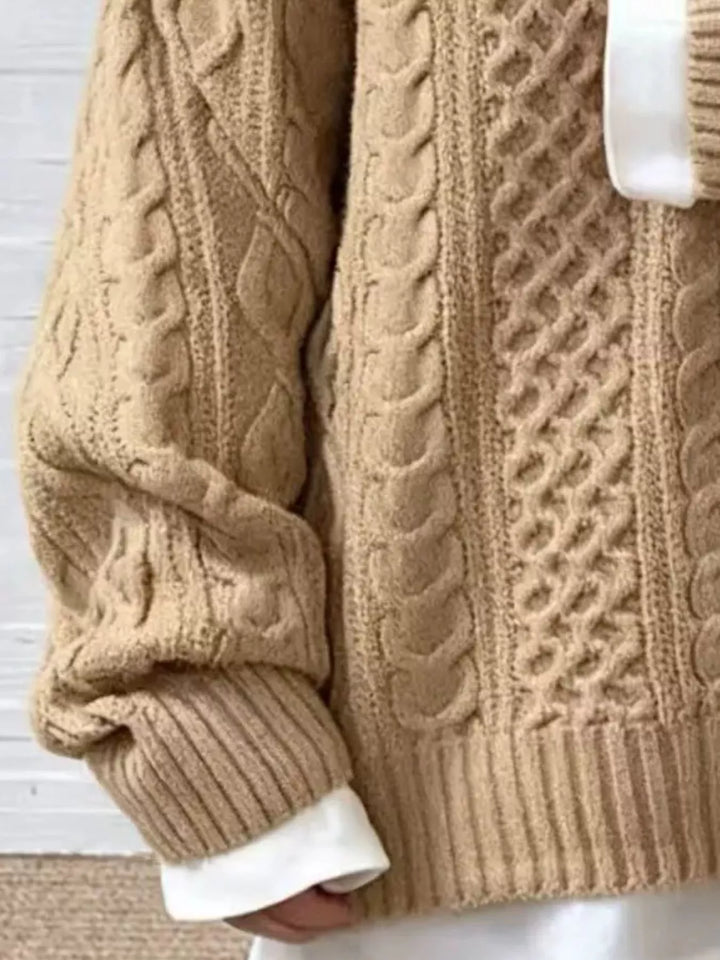 Close-up of the khaki cable knit pattern and ribbed cuff