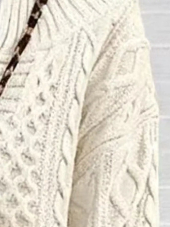 Close-up of the off-white cable knit texture and strap detail