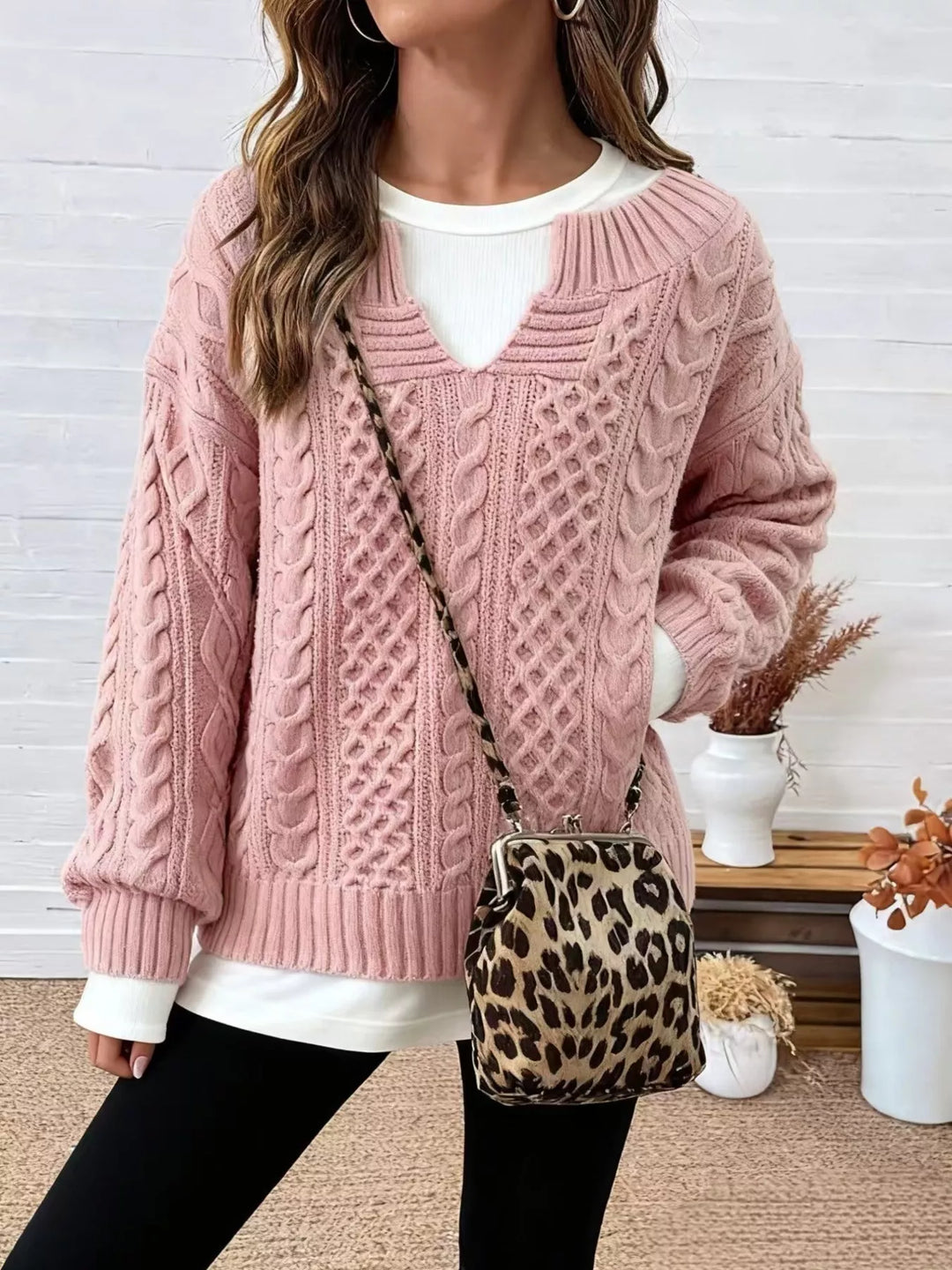 Pink oversized cable knit v neck sweater with side slits, front view