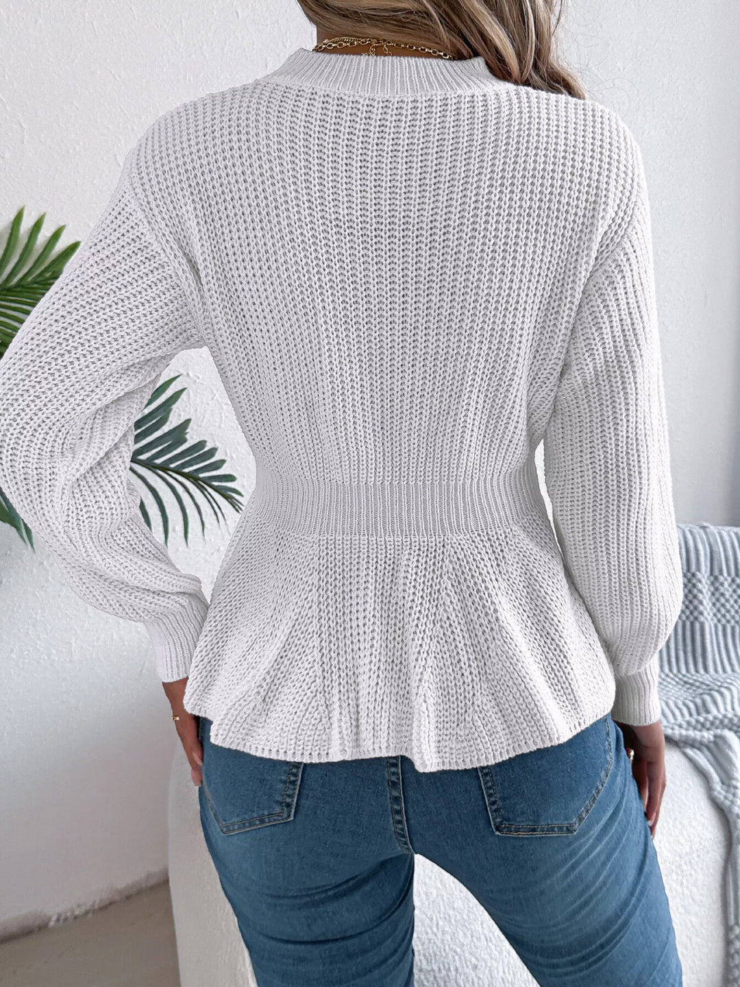 Back view of the white peplum hem sweater with ribbed texture