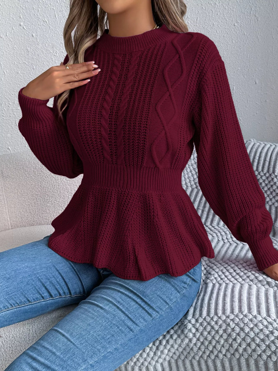 Burgundy round neck sweater with hand raised, styled with jeans