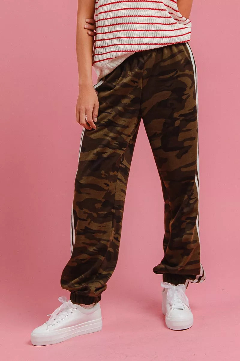Women's camo pants with side stripes, relaxed track style, front view