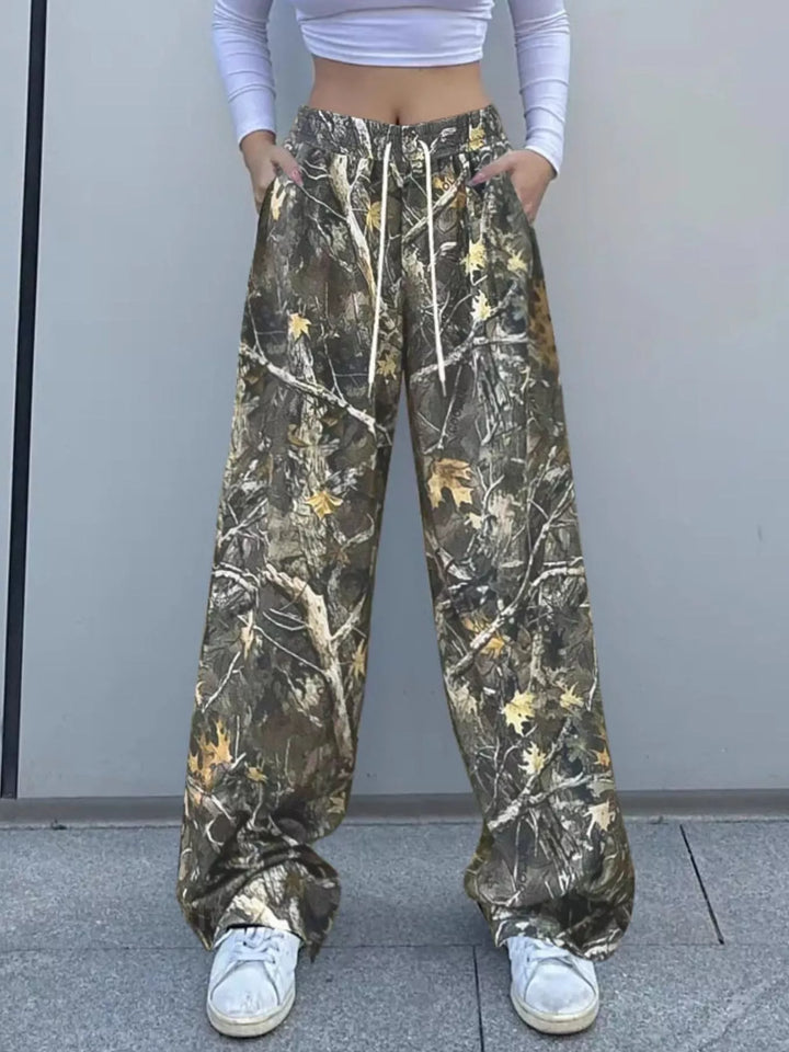 Women's camo pants, relaxed wide leg with drawstring waist, styled with white sneakers