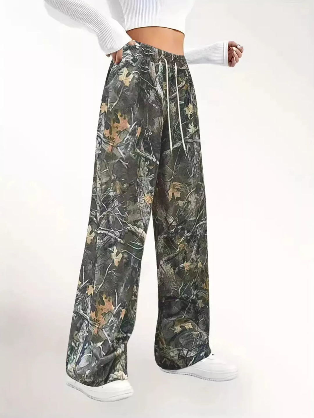 Side angle of the relaxed camo pants with a hand in the pocket