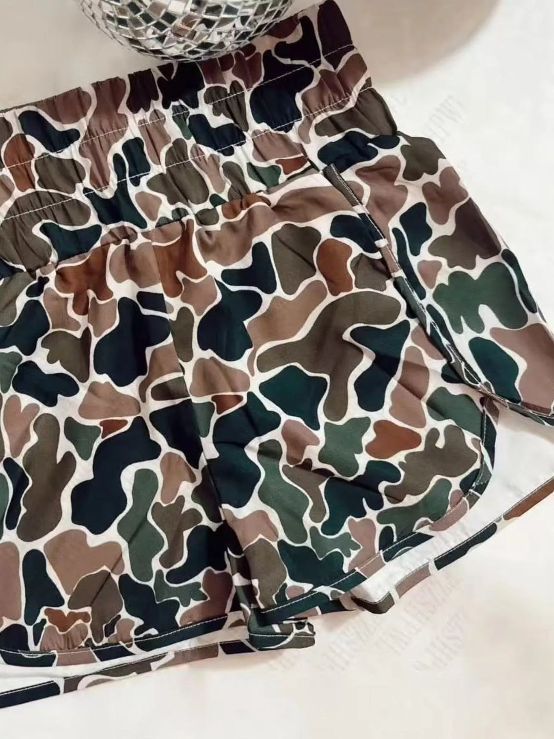 Woodland camo shorts close-up of the elastic waistband and white inner lining