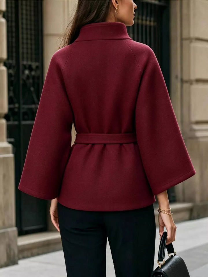Asymmetric button tie belt stand collar in burgundy, back view