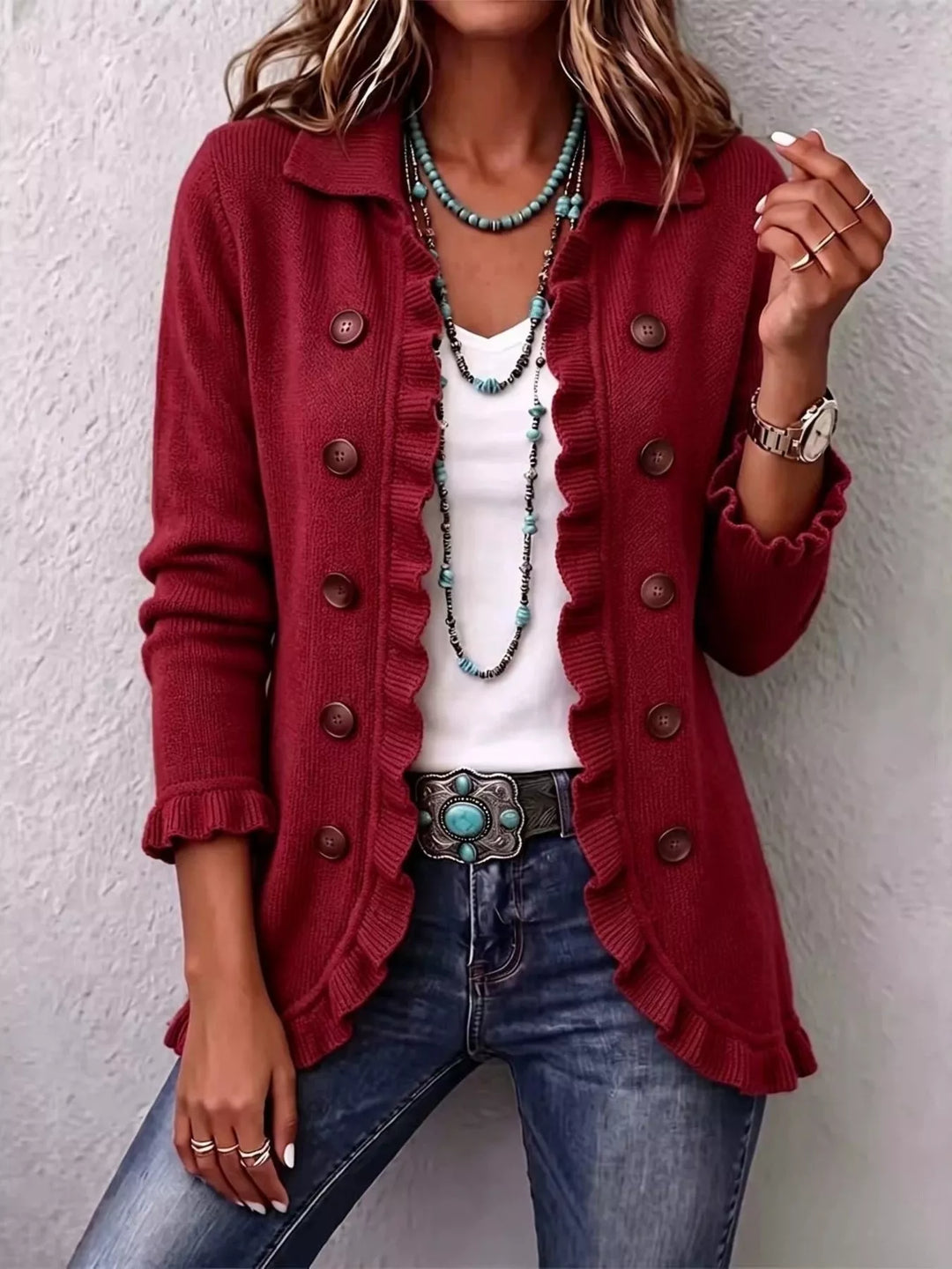 Women's burgundy cardigan with button front, collar and ruffle trim, worn with jeans