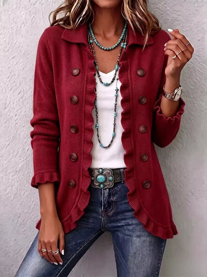 Women's burgundy cardigan with button front, collar and ruffle trim, worn with jeans