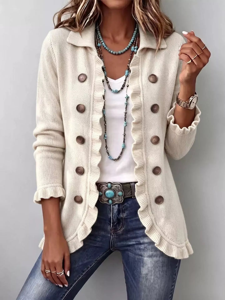 Cream button front cardigan with collar and ruffle trim, styled with a beaded necklace