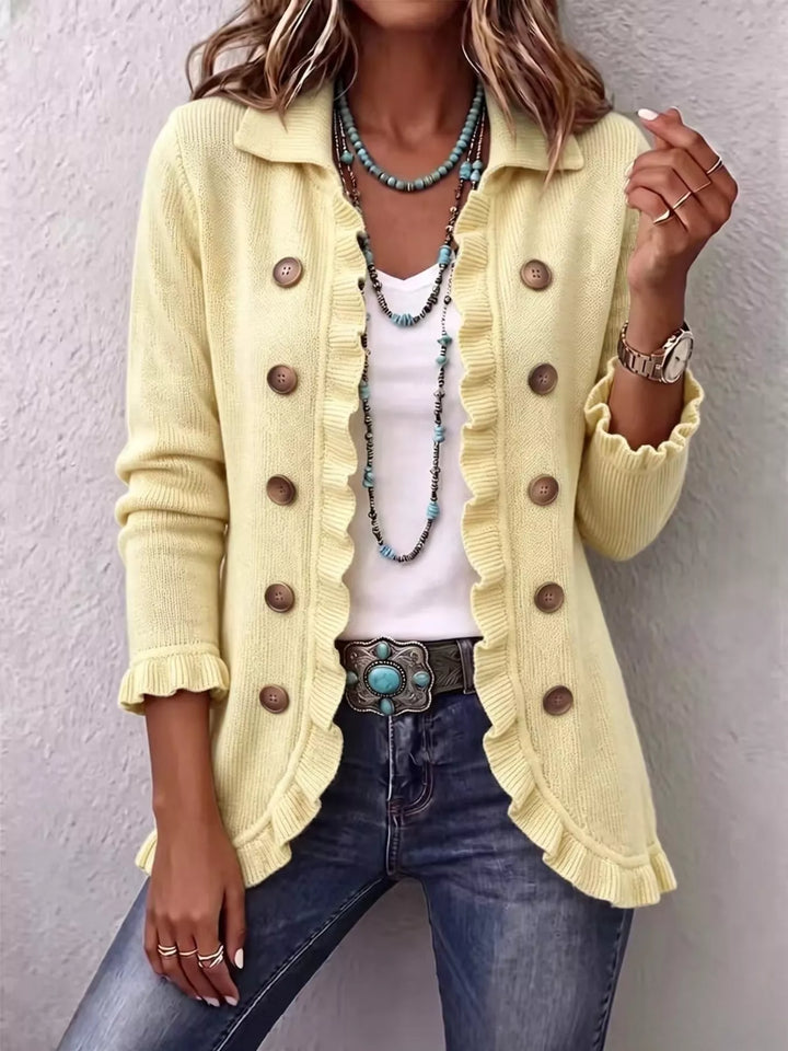 Pale yellow collared cardigan with ruffle trim and button front, front view