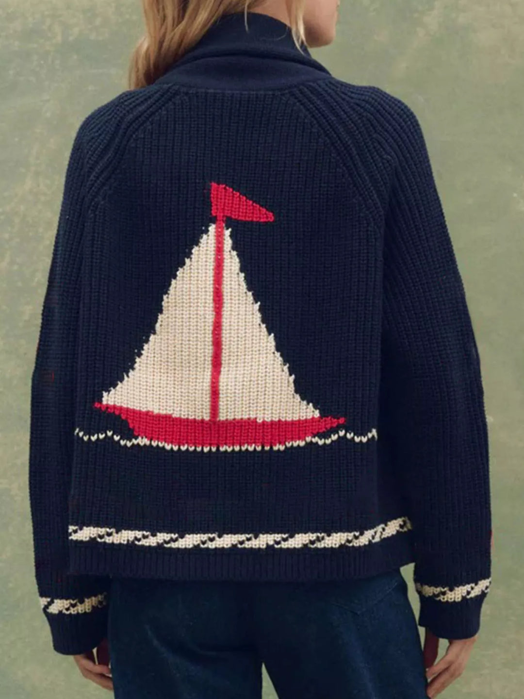 Back view of the navy cardigan with a large sailboat motif