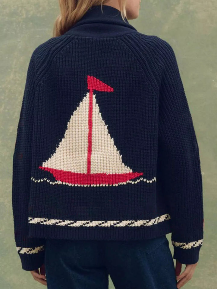 Back view of the navy cardigan with a large sailboat motif