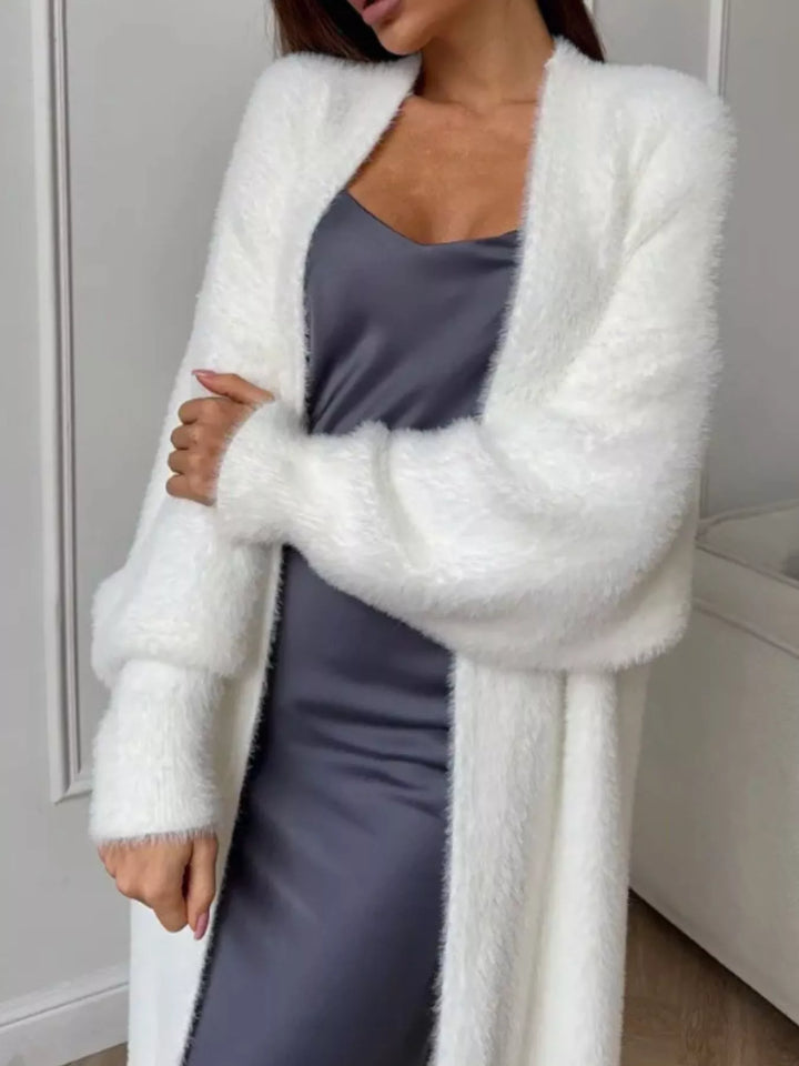 Close-up of ivory fuzzy cardigan with a dropped shoulder and puffed sleeve