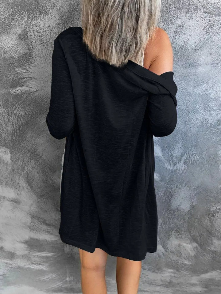 Black longline cardigan from the back with an off the shoulder drape