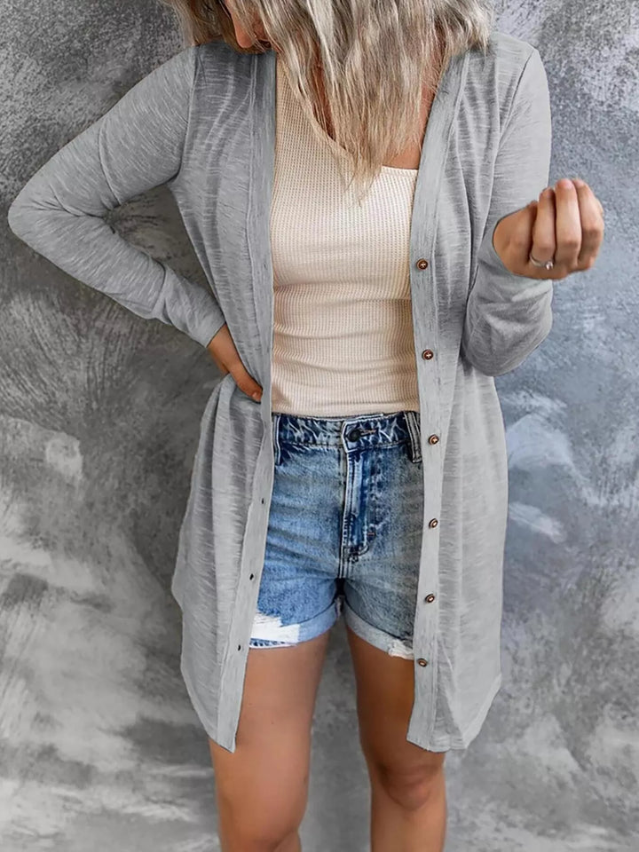 Lightweight gray cardigan with long sleeves and button closure, hand on hip