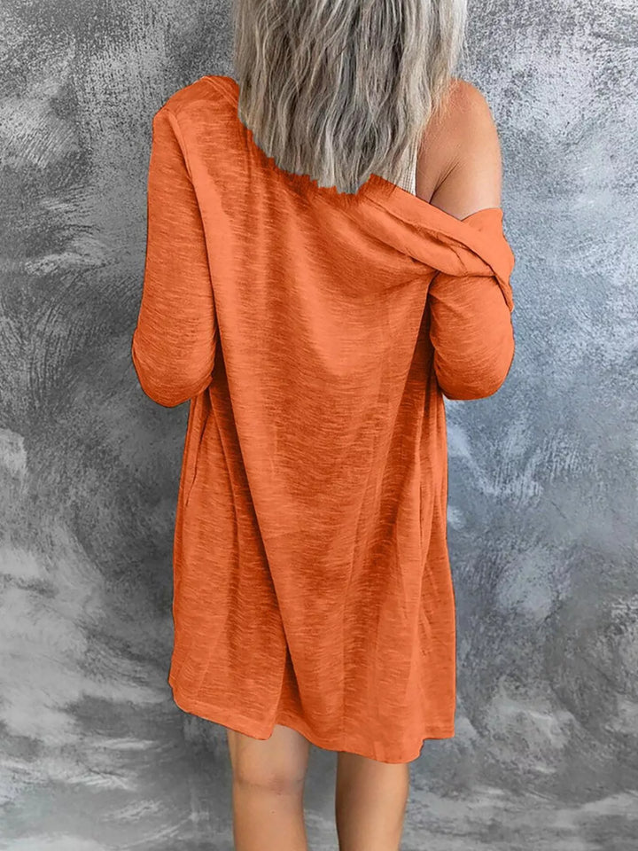 Back view of orange lightweight cardigan with a loose fit