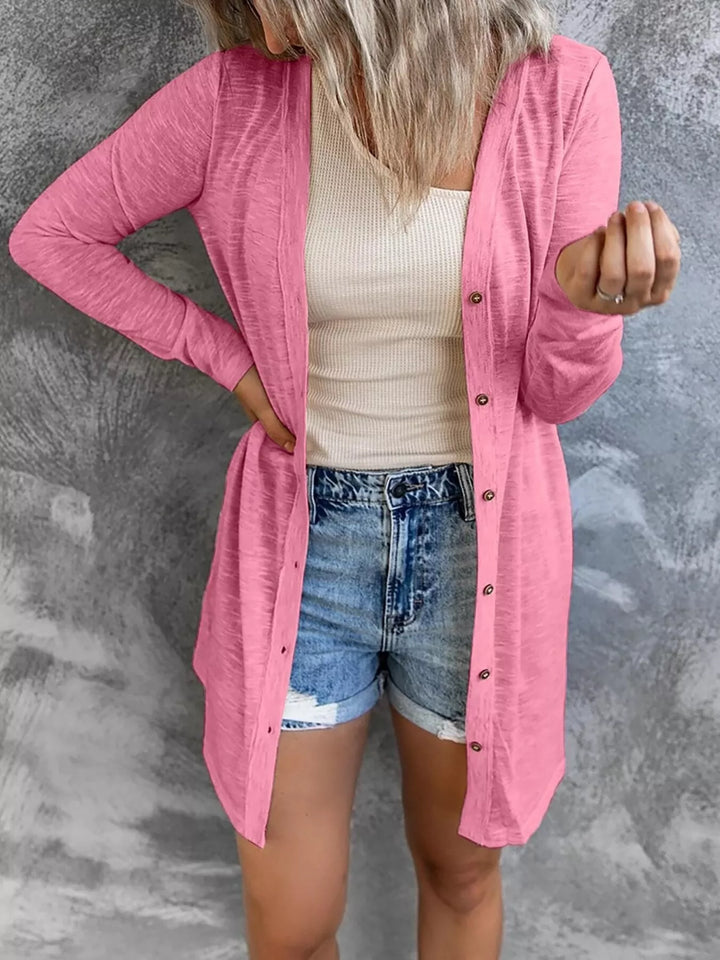 pink longline button front cardigan styled over a tank top and denim shorts