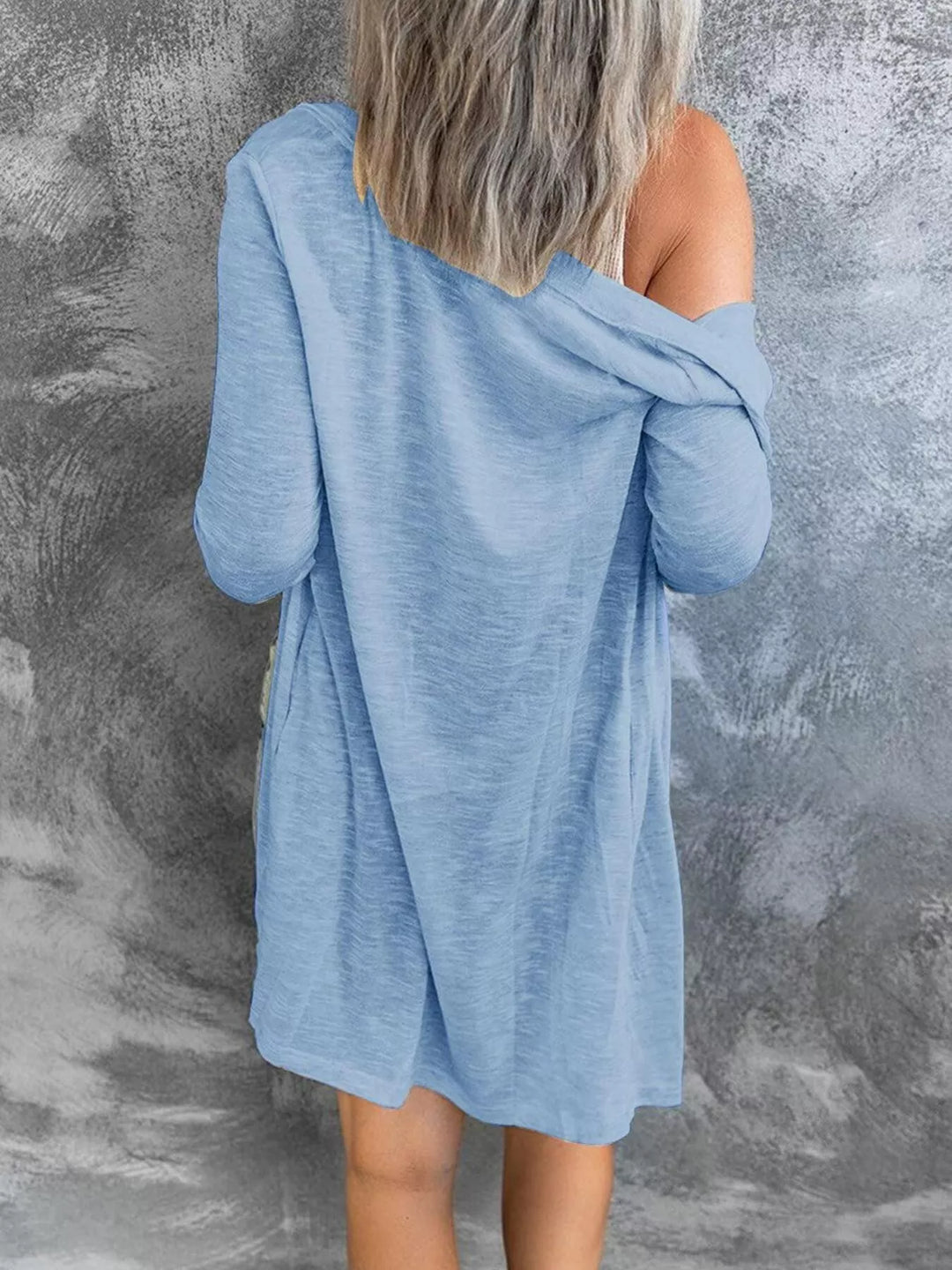 Sky blue lightweight cardigan seen from behind, off the shoulder