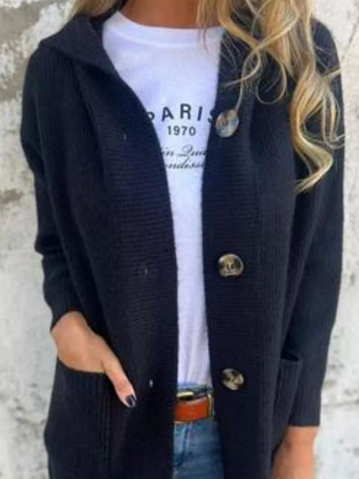Close-up of the black cardigan buttons and hood over a white tee