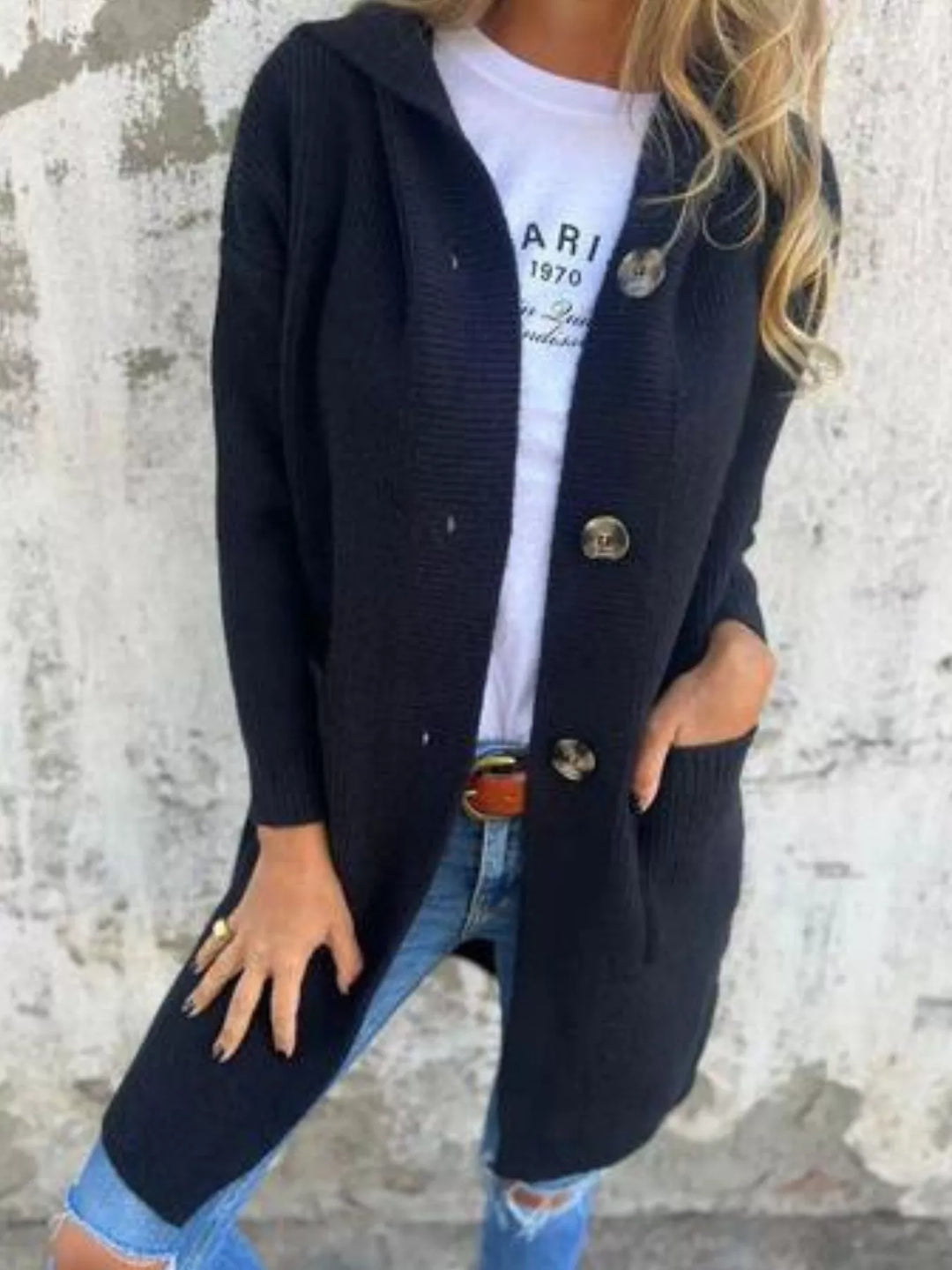 Black long hooded cardigan with button front over a graphic white tee and denim