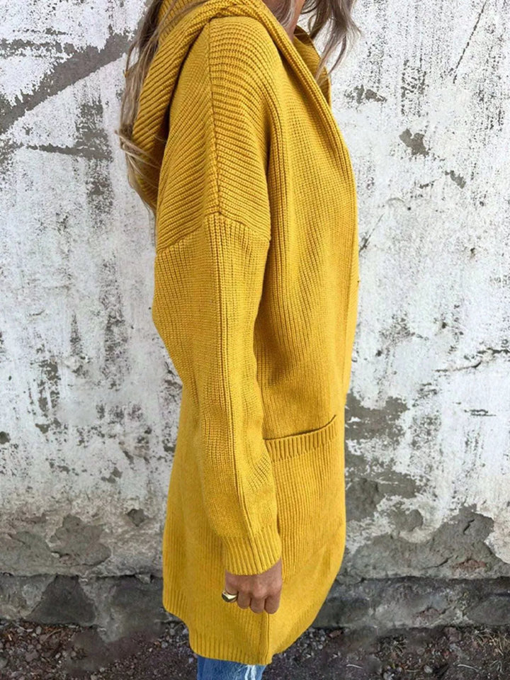 Side view of the mustard hooded cardigan showing the pocket and sleeve