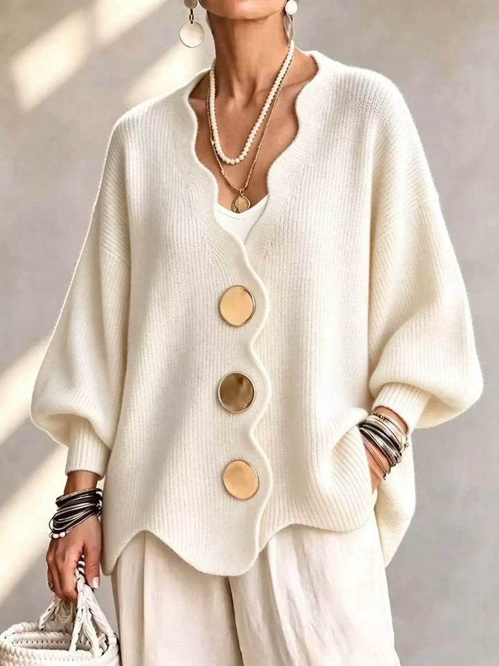 Women's cardigan in cream with scalloped edge and large gold buttons, front view