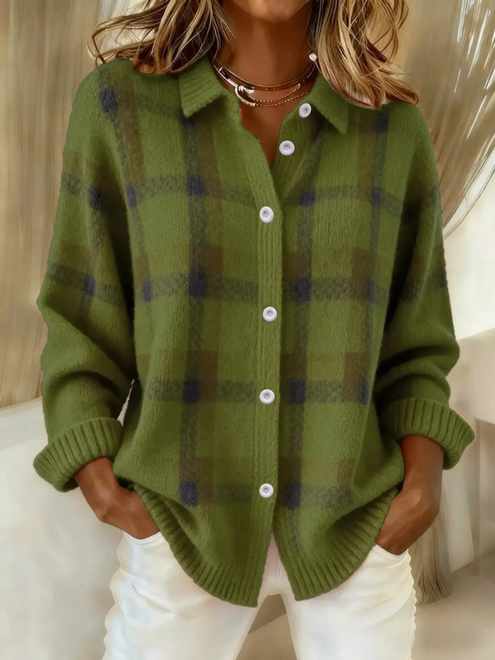 Olive green plaid button up cardigan, front view with hands in pockets