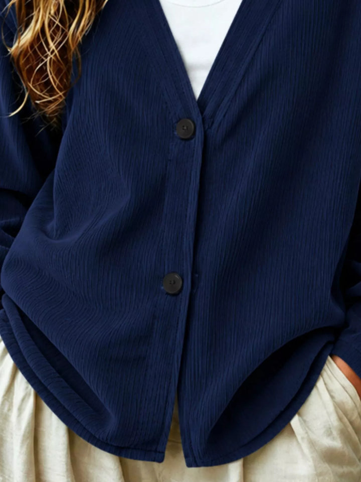 Corduroy-look ribbed v-neck button up in dark blue, close-up detail