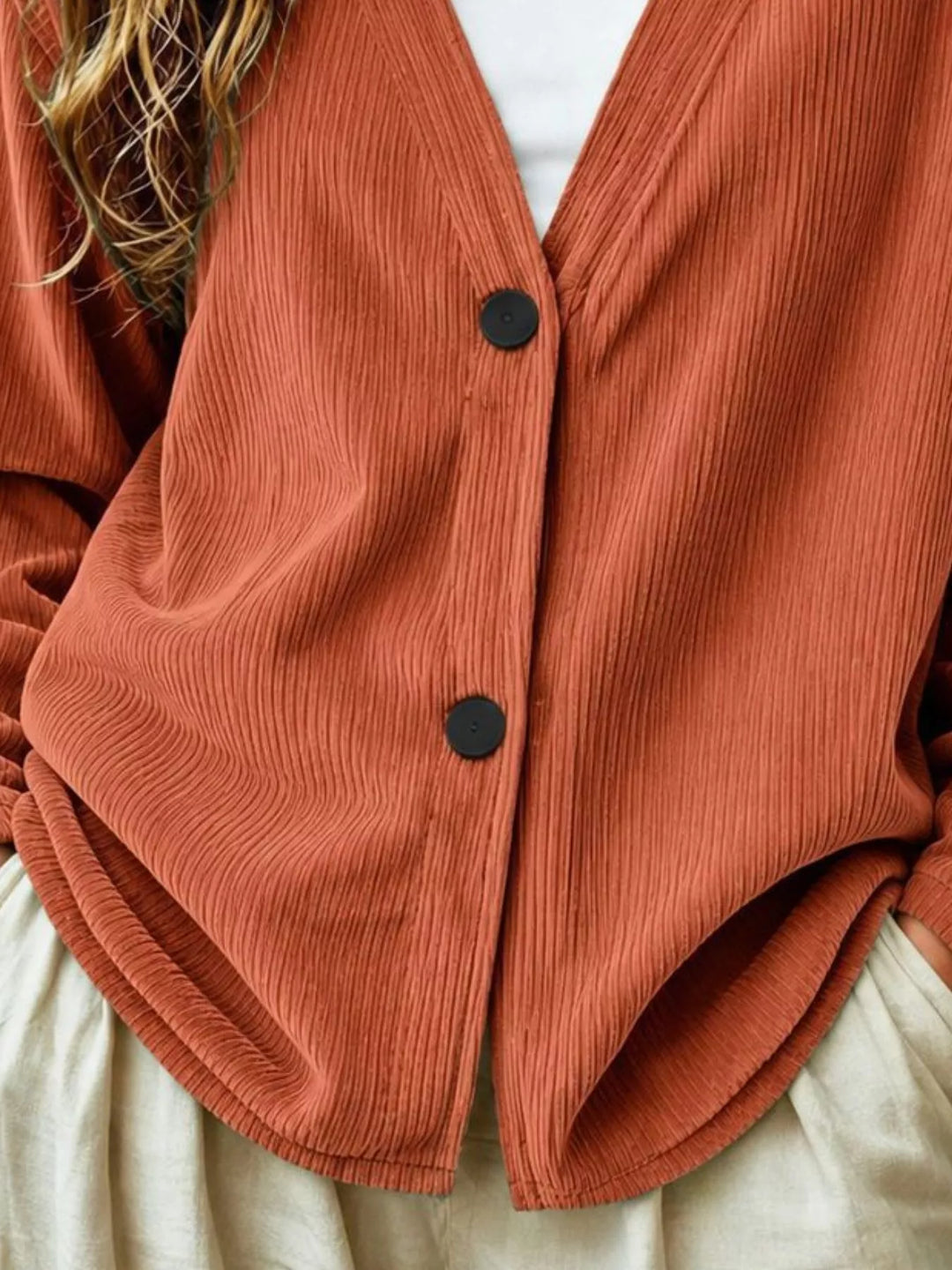 Corduroy-look ribbed v-neck button up in terracotta, close-up detail