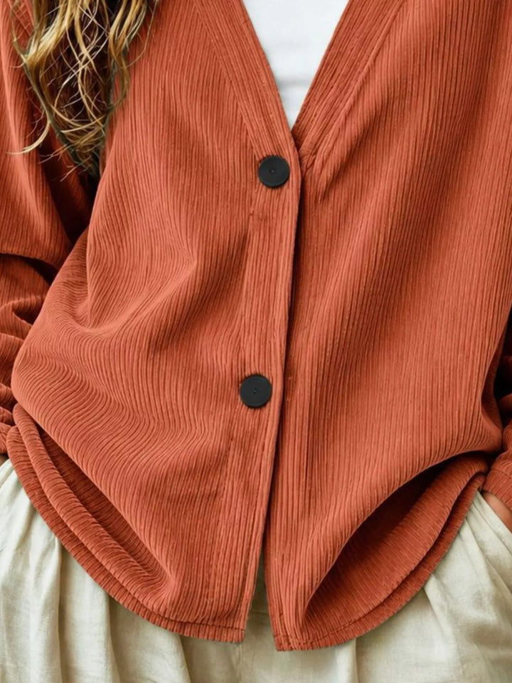 Corduroy-look ribbed v-neck button up in terracotta, close-up detail
