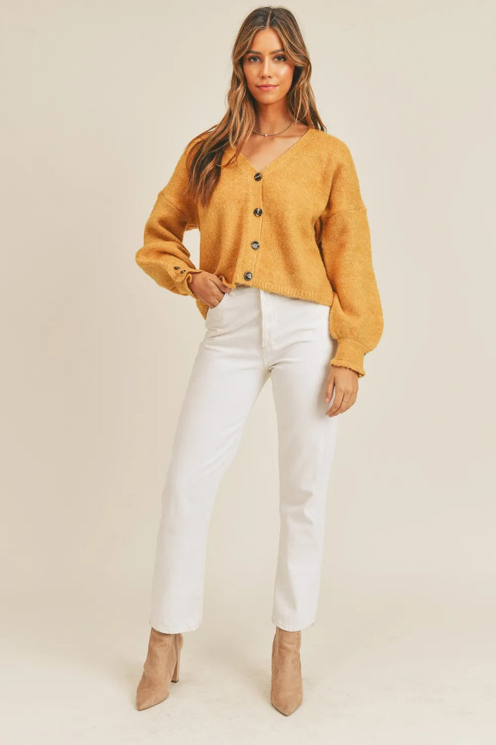 Cropped v-neck balloon sleeve in mustard, styled on model 2
