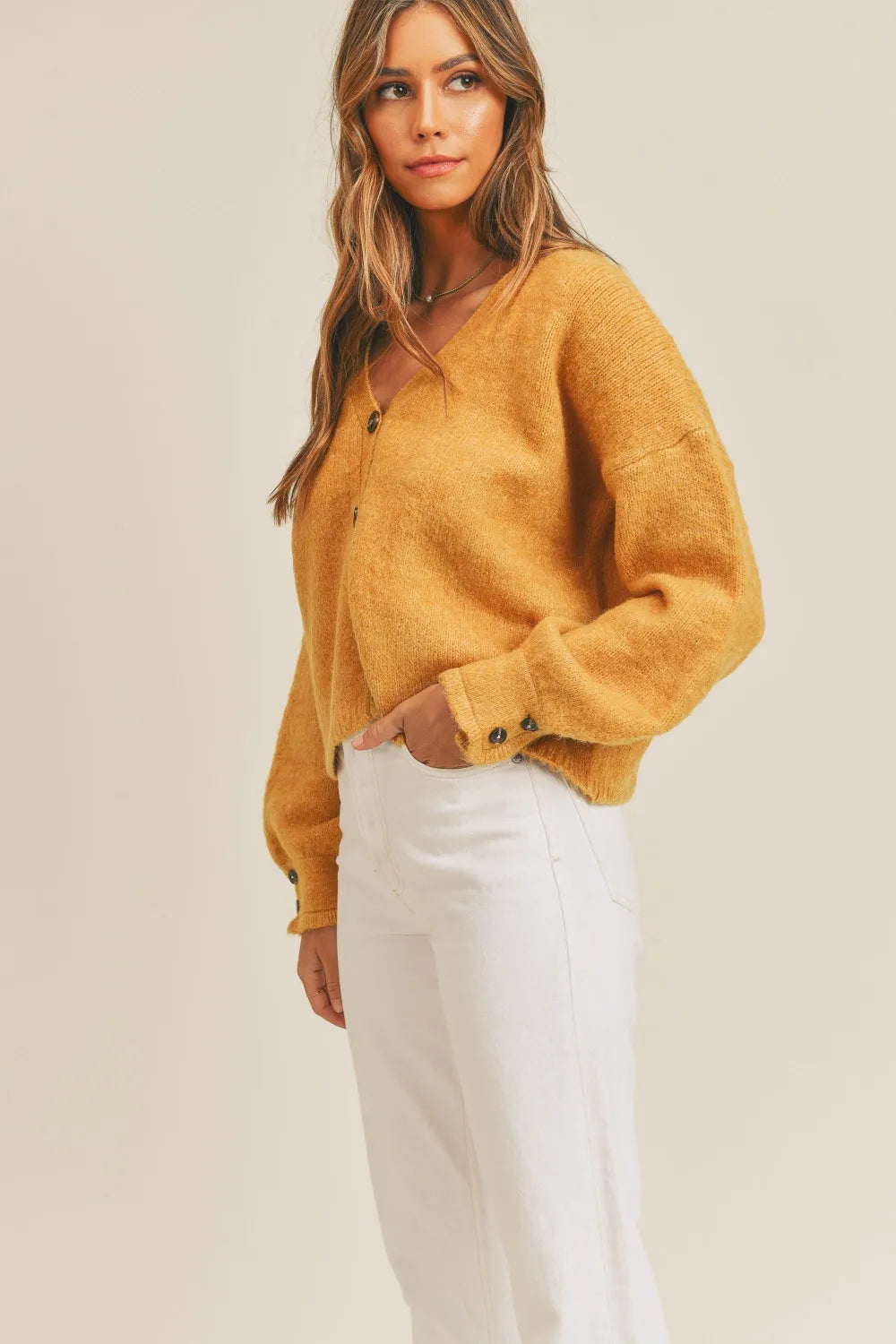 Cropped v-neck balloon sleeve in mustard, styled on model
