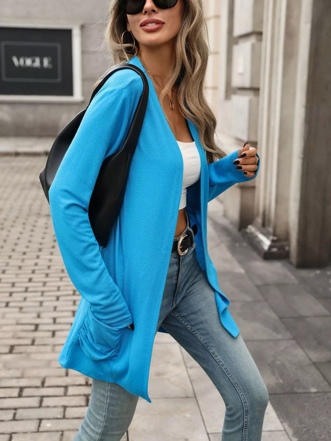 Open front waterfall drape thumbholes in blue, styled on model