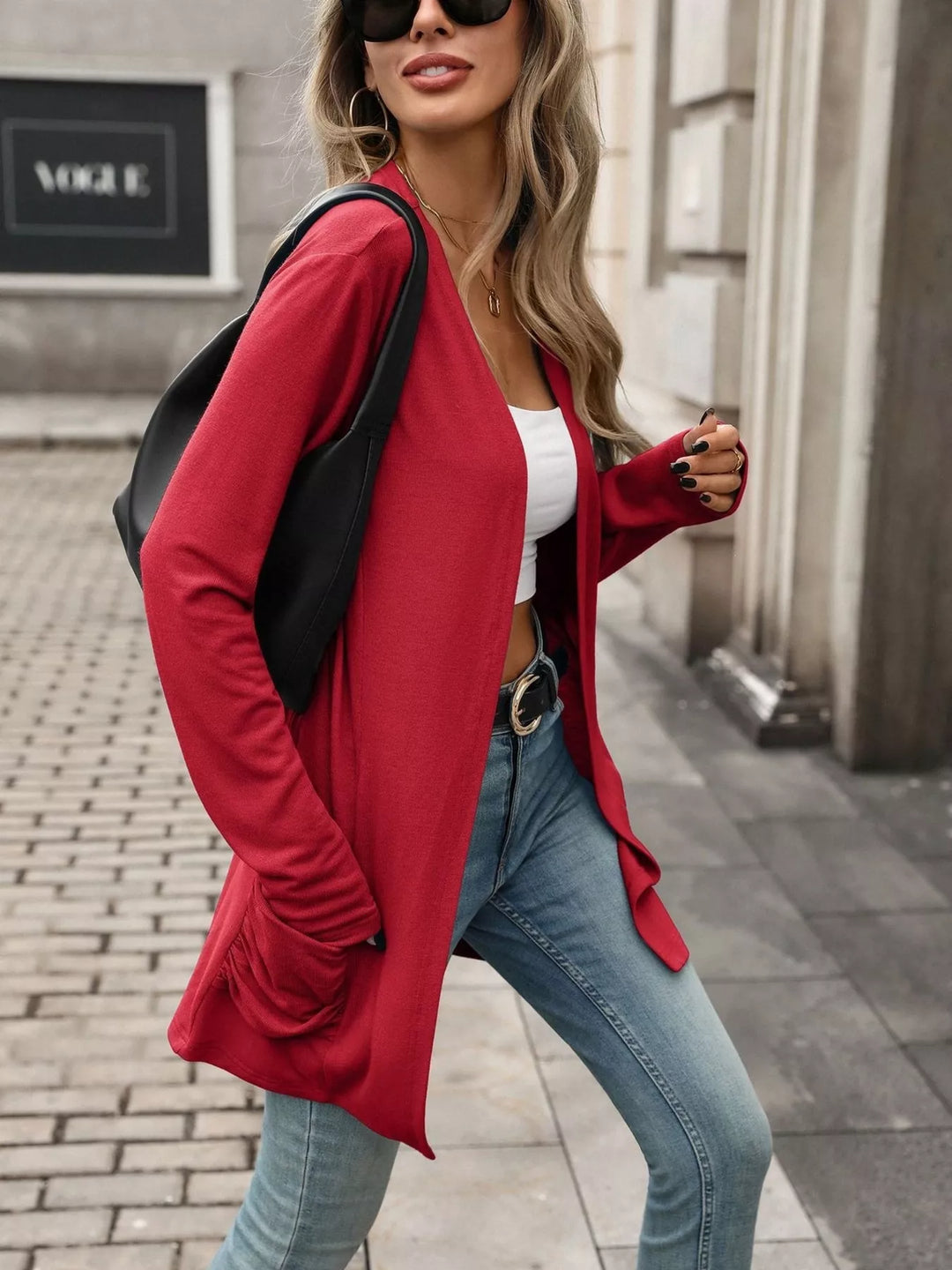 Open front waterfall drape thumbholes in red, styled on model