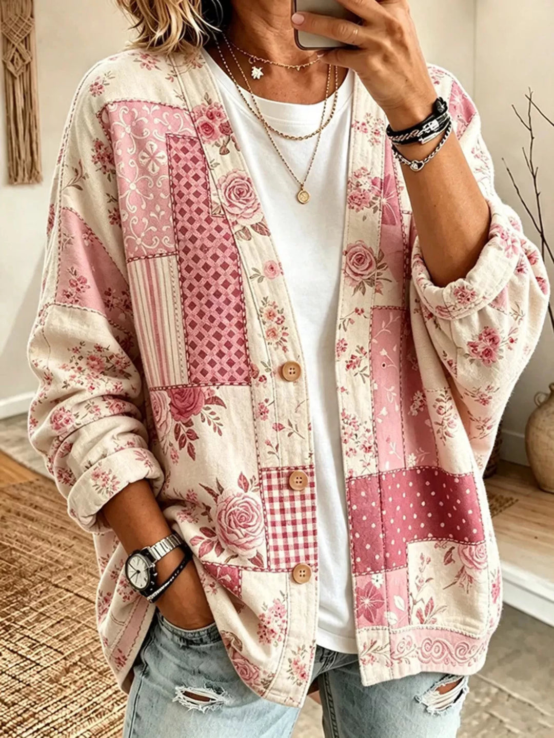 Pink floral patchwork cardigan worn open over a white tee with jeans