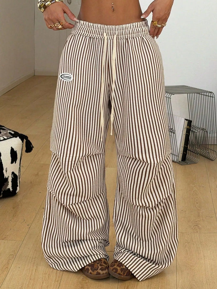 Pinstripe wide leg pants with drawstring and small logo patch, front view