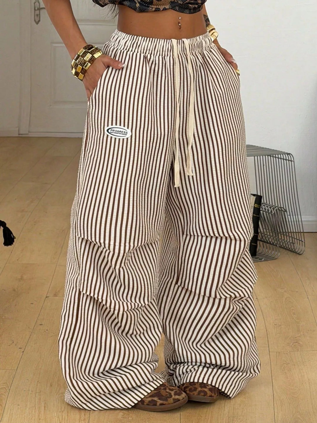 Women's brown pinstripe cargo pants, wide leg with drawstring waist, front view