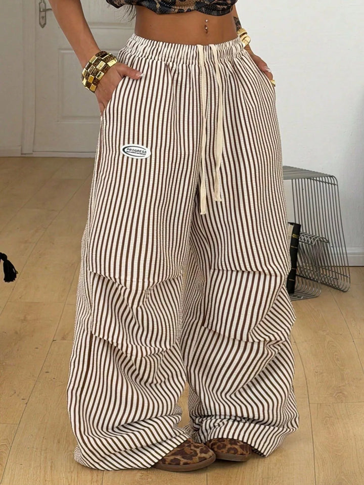 Women's brown pinstripe cargo pants, wide leg with drawstring waist, front view
