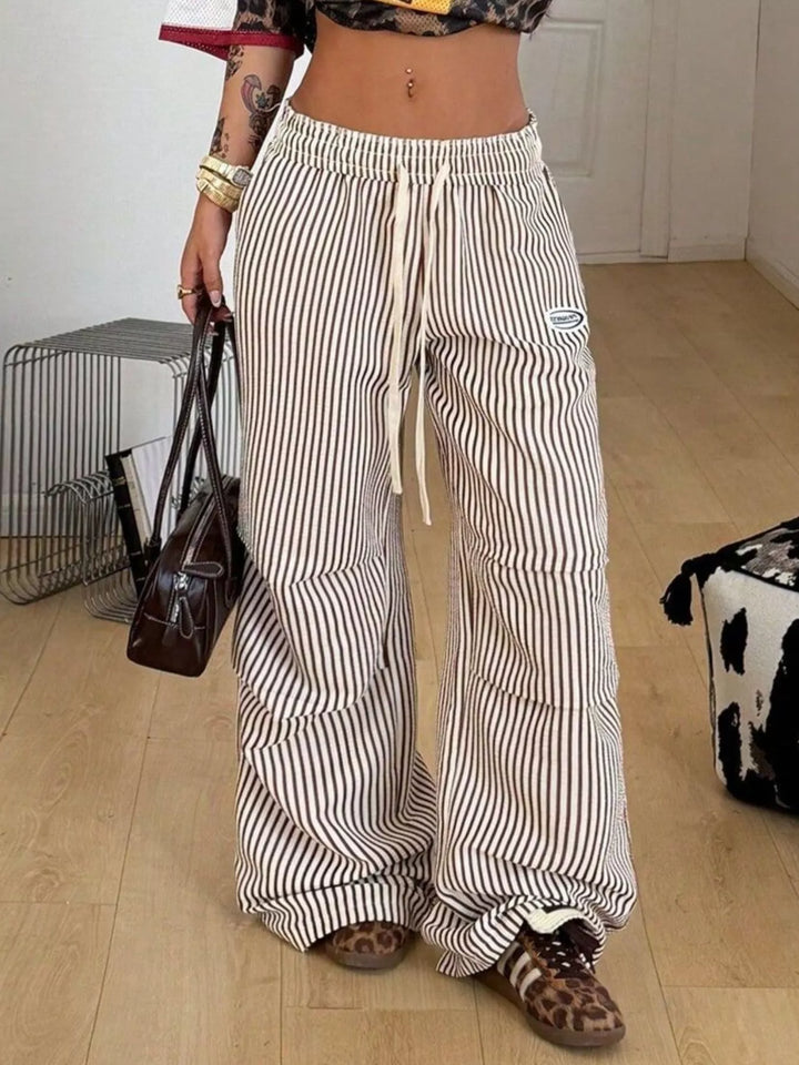 Brown pinstripe cargo pants styled with a leopard print top and a dark handbag