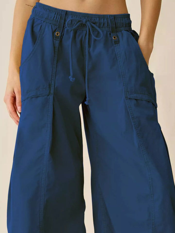 Close-up of cobalt blue cargo pants waistband and side pocket